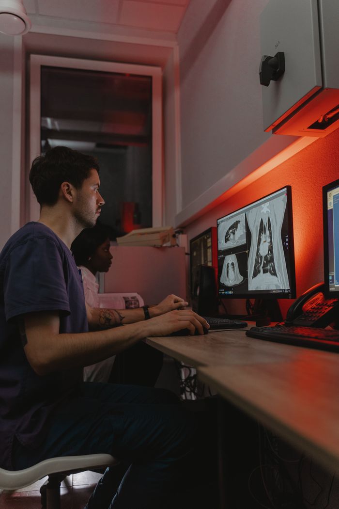 Offerings Doctors reviewing diagnostic X-ray images on computer in a clinical setting.